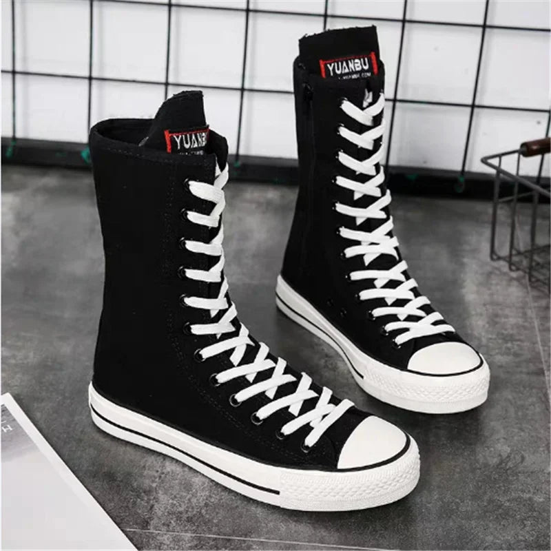 Black high-top platform sneakers with white laces and rubber soles for women