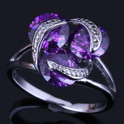 Silver plated ring with round purple cubic zirconia stones in a classic tension setting design