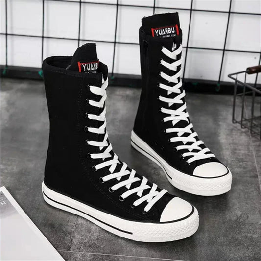 Black high-top platform sneakers with white laces and rubber soles for women